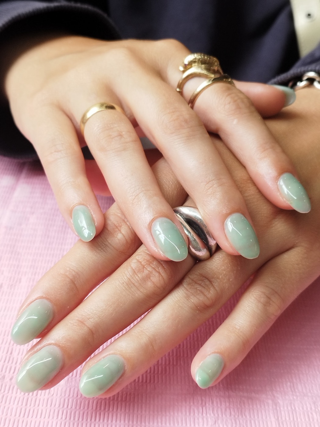 A soft sage-green ombre gel manicure with a chrome accent nail, done by May at Wick Lane Nails