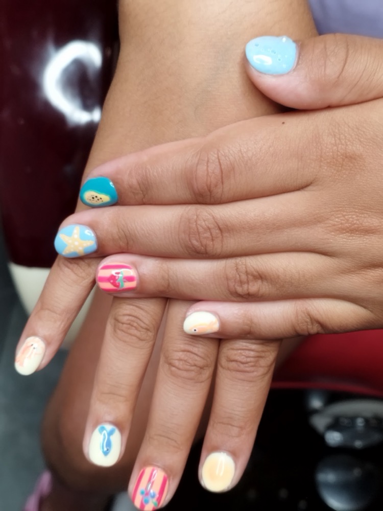 Colourful under-the-sea nail art with starfish and shells, done for a child